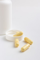 Fototapeta na wymiar pills and bottle isolated on white background
