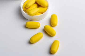 yellow pills isolated on white background
