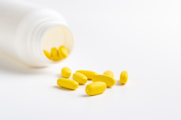 yellow pills isolated on white background