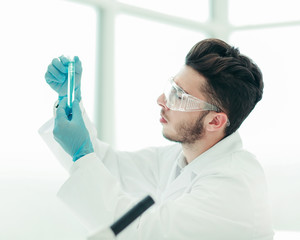 close up. scientist with a medical tube standing in the lab