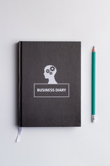 business diary and pencil on white background isolated