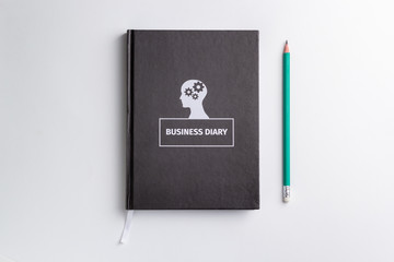 business diary and pencil on white background isolated