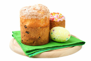 Easter cakes with colored egg on a cutting board