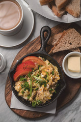 Breakfast table with scrambled eggs with coffee