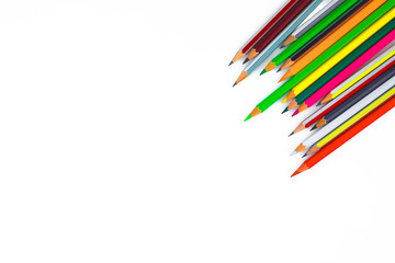 Different colored wood pencil crayon gathered in a row pointing downwards