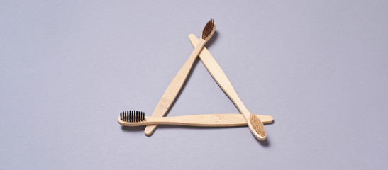 Set of bamboo toothbrushes. Different color. Ecology wood tooth brush group. Grey background. Natural oral hygiene. Dental zero waste protection