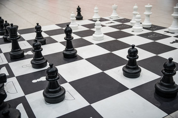 mannequins from chess game on black and white squares