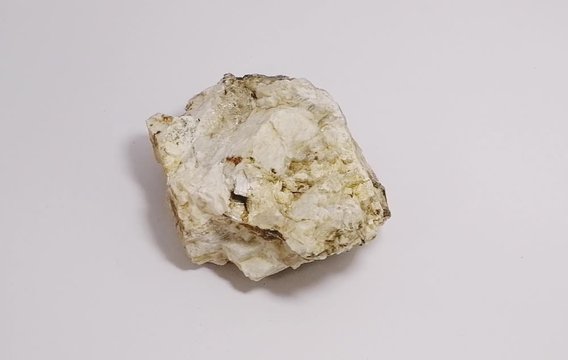 specimen of muscovite biotite granite stone on white background. mineral stone.