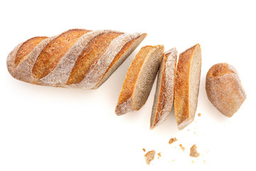 Freshly baked bread isolated on a white background. Crumbs and Bread slice close up. Top view.