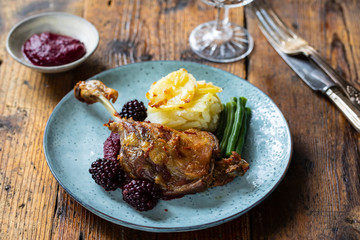 Roast duck leg with beetroot and blackberry puree and dauphinois potatoes