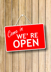 Come in we re open text sign on wooden background