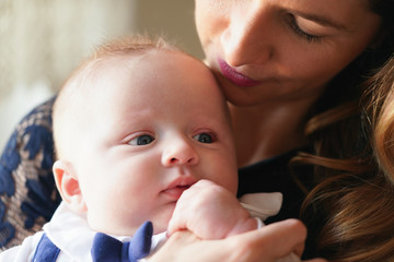 Young mother with her baby son, detail on heads close together