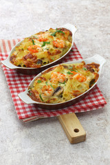 homemade baked shrimp macaroni cheese gratin, casserole dish