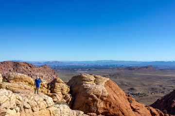 Fototapeta premium Las Vegas view man tourist backpacker red rock mountains landscape Red Rock Canyon National Conservation Area Nevada’s Mojave Desert