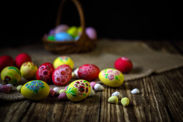 Easter composition on wooden background. Hand painting Easter eggs. The concept of religious holidays, family traditions. Selective focus.