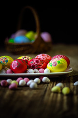 Easter composition on a wooden background. Hand painting Easter eggs. The concept of religious holidays, family traditions. Selective focus.