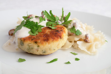 turkey cutlet with pasta under sour cream chanterelles  sauce sprinkled with parsley