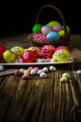 Easter composition on a wooden background. Hand painting Easter eggs. The concept of religious holidays, family traditions. Selective focus.