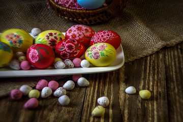 Easter composition on a wooden background. Hand painting Easter eggs. The concept of religious holidays, family traditions. Selective focus.