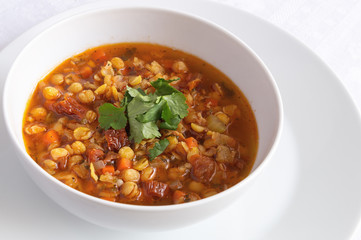  a bowl of pea soup vegetables decorated with cilantro leafs