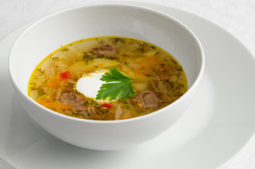cabbage soup with sour cream decorated with parsley leaf