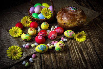 Easter composition with traditional Russian Easter bread kulich. Hand painting Easter eggs. The concept of religious holidays, family traditions. Selective focus.