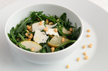honey poached pear arugula salad with bryndza cheese and pine nuts dressed with white wine vinegar and oil