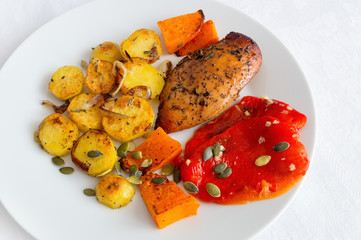 chicken breast roasted in spices with autumn vegetables and seeds