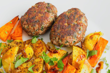 meatballs with roasted potato and pumpkin decorated with parsley