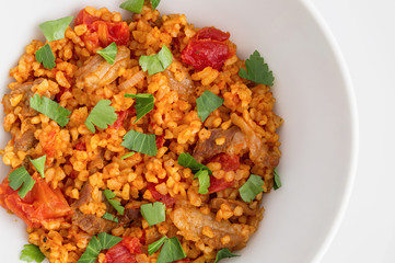 wheat pilaf with mutton decorated with parsley