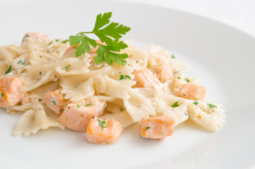 farfalle salmon pasta with cream sauce decorated with parsley