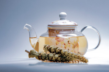 Herbal infusion in a tea pot, loose dried herbs displayed - ironwort (Sideritis, Mountain Tea or shepherd's tea)