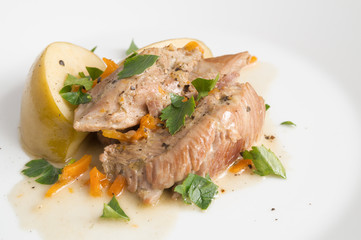 turkey chops stewed with vegetables and apples decorated with parsley