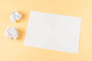 White empty sheet of paper on beige background.