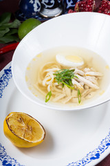 White bowl of egg noodle soup