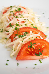 bright salad with tomatoes and white cabbage sprinkled with parsley