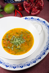 Yellow curry soup in a white bowl