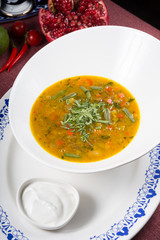 Yellow curry soup in a white bowl