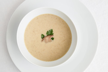 mushroom cream soup decorated with porcino and parsley 