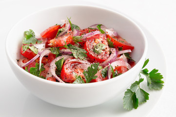 tomato salad with red onion, parsley, and black pepper