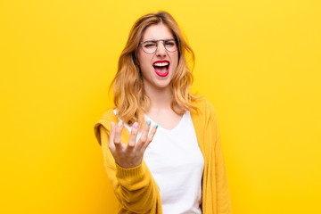 young pretty blonde woman looking angry, annoyed and frustrated screaming wtf or what‚Äôs wrong...