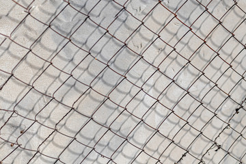 Fototapeta premium Old concrete wall, natural texture. Light background. The shadows.