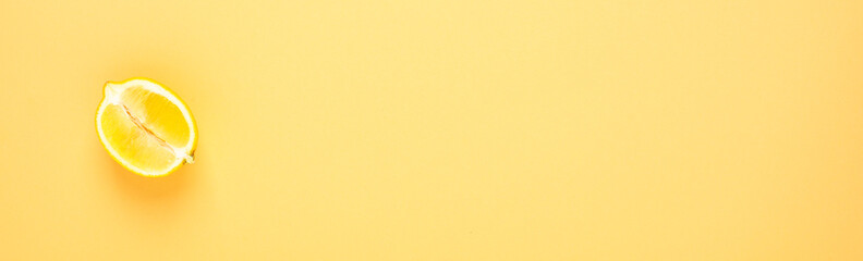 A slice of lemon on a yellow background. Flat lay composition