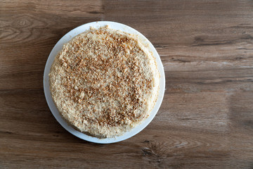 Dessert Napoleon cake close-up. Napoleon cake on a wooden table. View from above. Place for your text