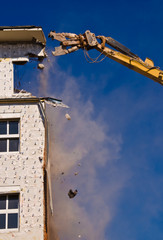 A building site, in which the house is demolished, with a crane
