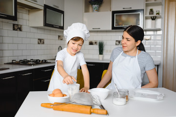 Happy family. Mother teaching her son how to cooking cake menu in morning. healthy lifestyle concept.. Baking Christmas cake and cook concept