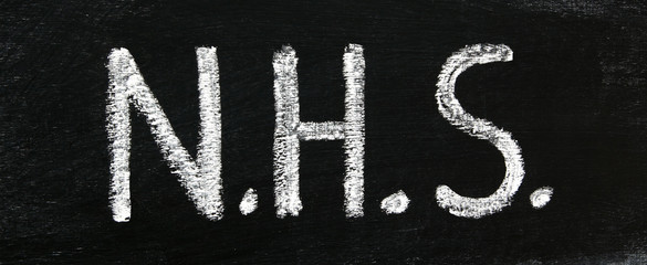 N.H.S - National Health Service - sign in real chalk letters on chalkboard, for nursing, teaching & educational concepts - panorama / header / banner.
