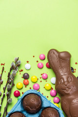Easter Background. Festive Chocolate Egg and Rabbit. Colorful Ester Sweet Food. Copy SPace, Top View
