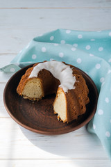 Delicious sweet cottage cheese Easter cupcake in a brown clay plate on a white plate with a blue napkin. Baking for the holiday of Holy Easter.