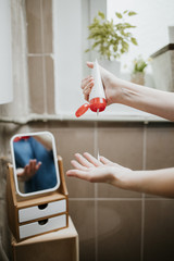 Closeup of a woman's hands applying hydrating cream to soften the skin. Nourishing skincare at home.